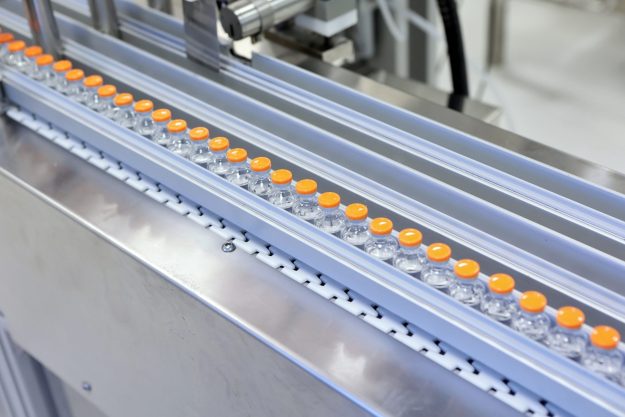 Sterile capsules for injection. Bottles on the bottling line of the pharmaceutical plant. Machine after checking sterile liquids. Interferon, nasoferon.